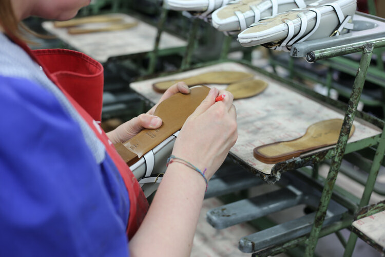 An artisan making a shoe.